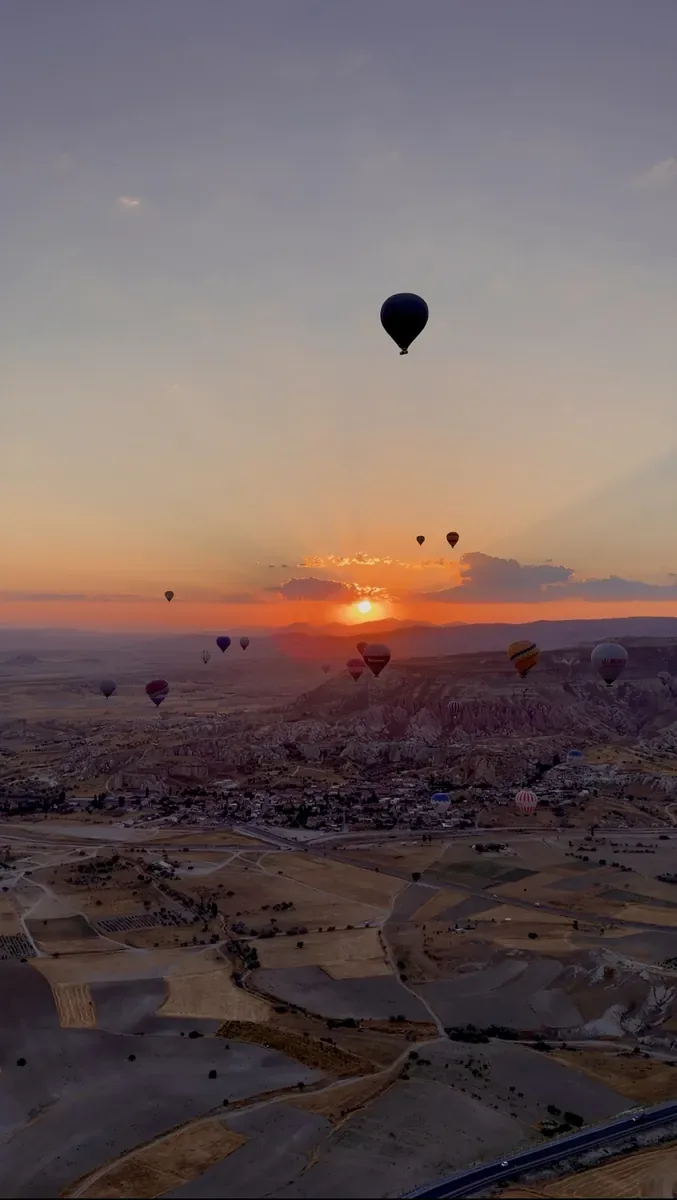 Globos aerostáticos volando sobre Göreme al amanecer en Capadocia