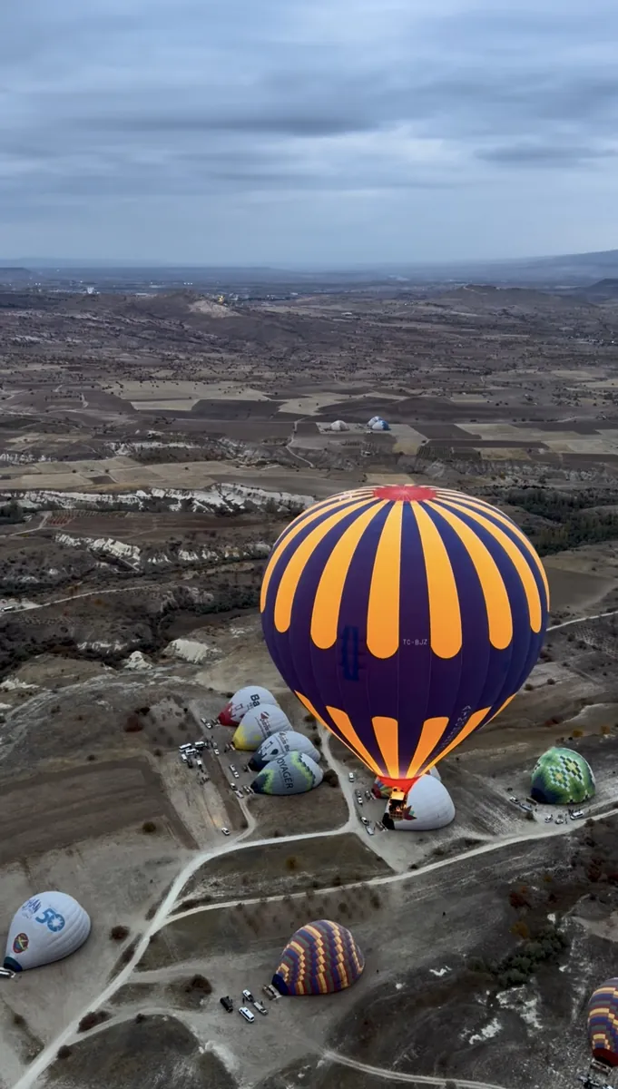 Aerial view of hot air balloons preparing for launch in Cappadocia